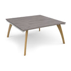 A square modern table with a grey wood-effect top and light natural wood legs, shown on a clean white background.