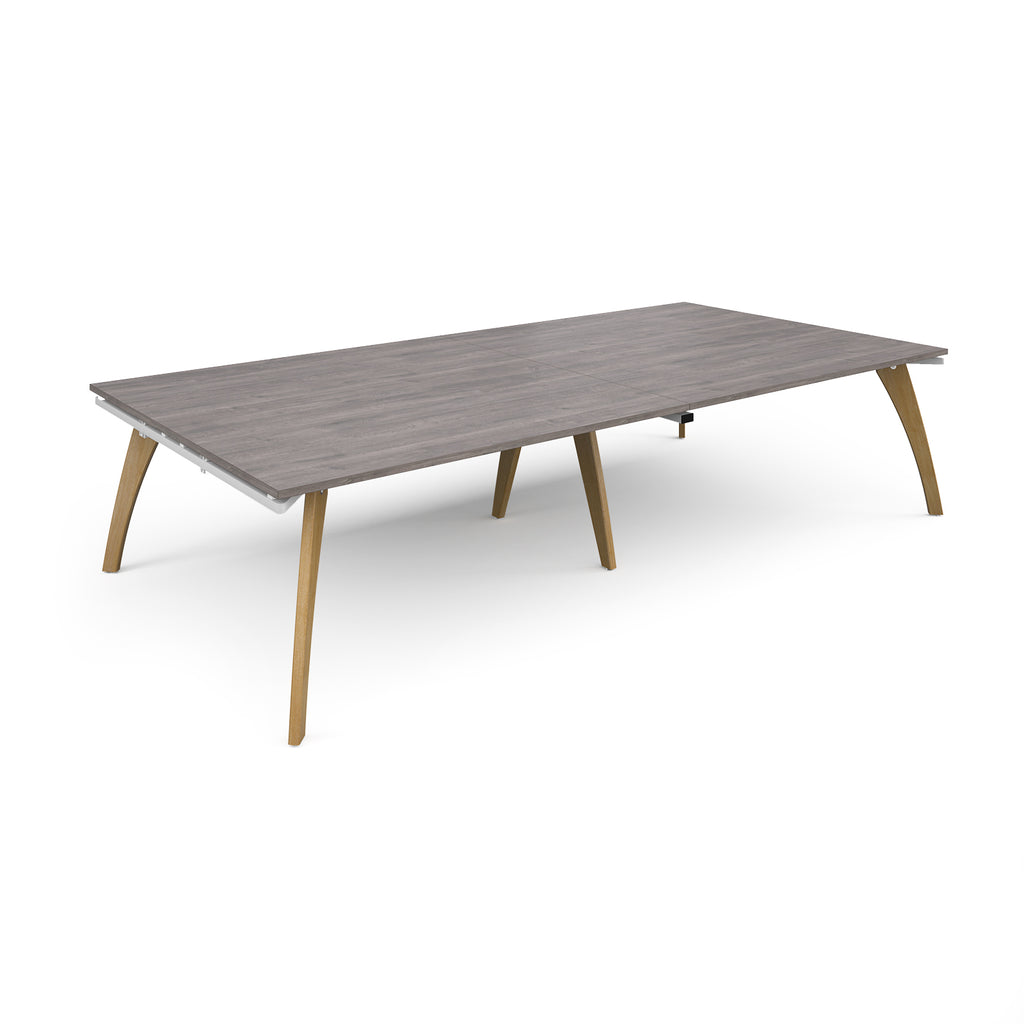 Rectangular table with a grey wood-effect top and wooden legs on a white background