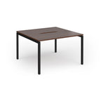 Back-to-back desk with wood-effect top and black metal frame on a white background
