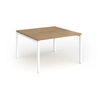Back-to-back desk with wood-effect top and white metal frame on a white background