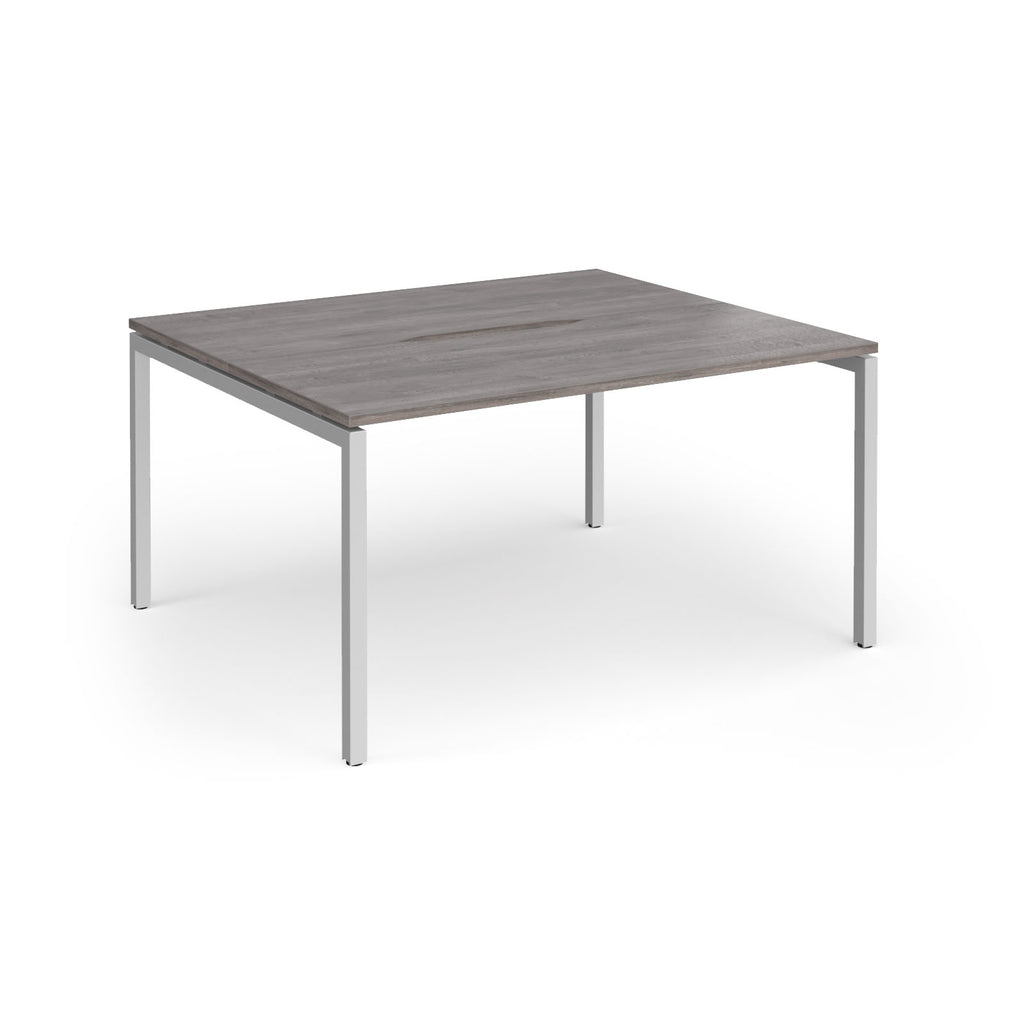 Back-to-back desk with grey wood-effect top and silver metal frame on a white background