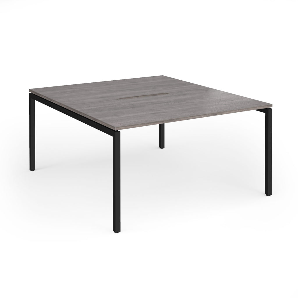 Office back-to-ack desk with grey wood-effect top and black metal frame on a white background