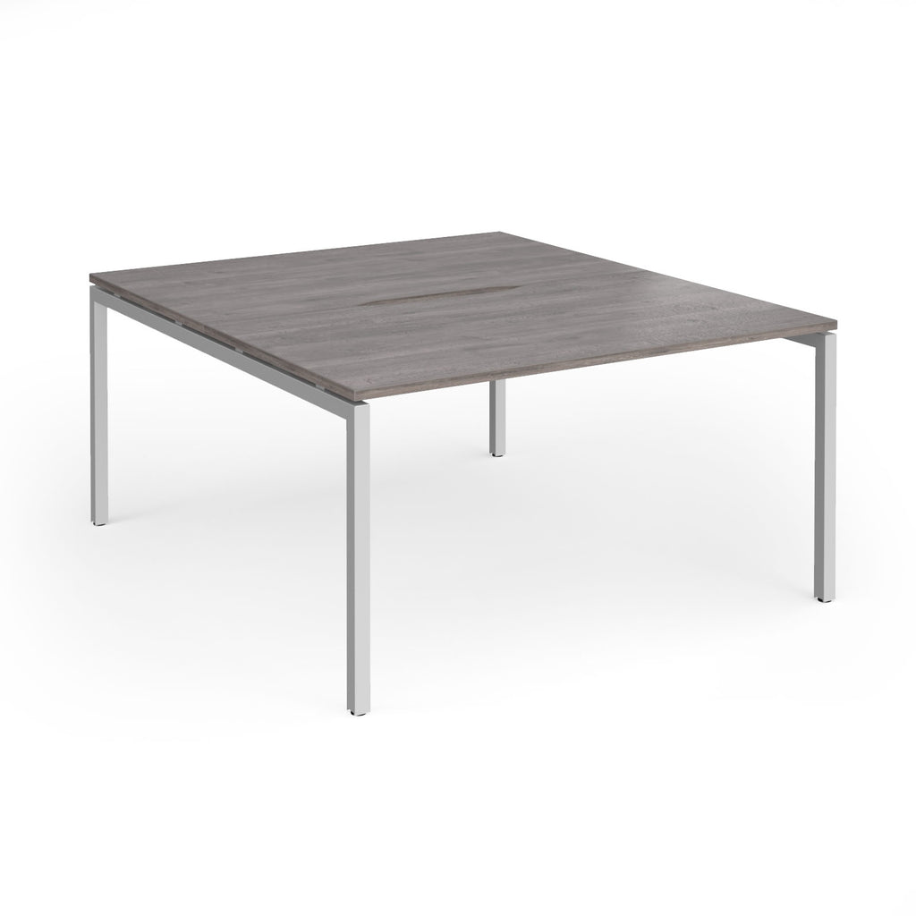 Office back-to-ack desk with grey wood-effect top and silver metal frame on a white background