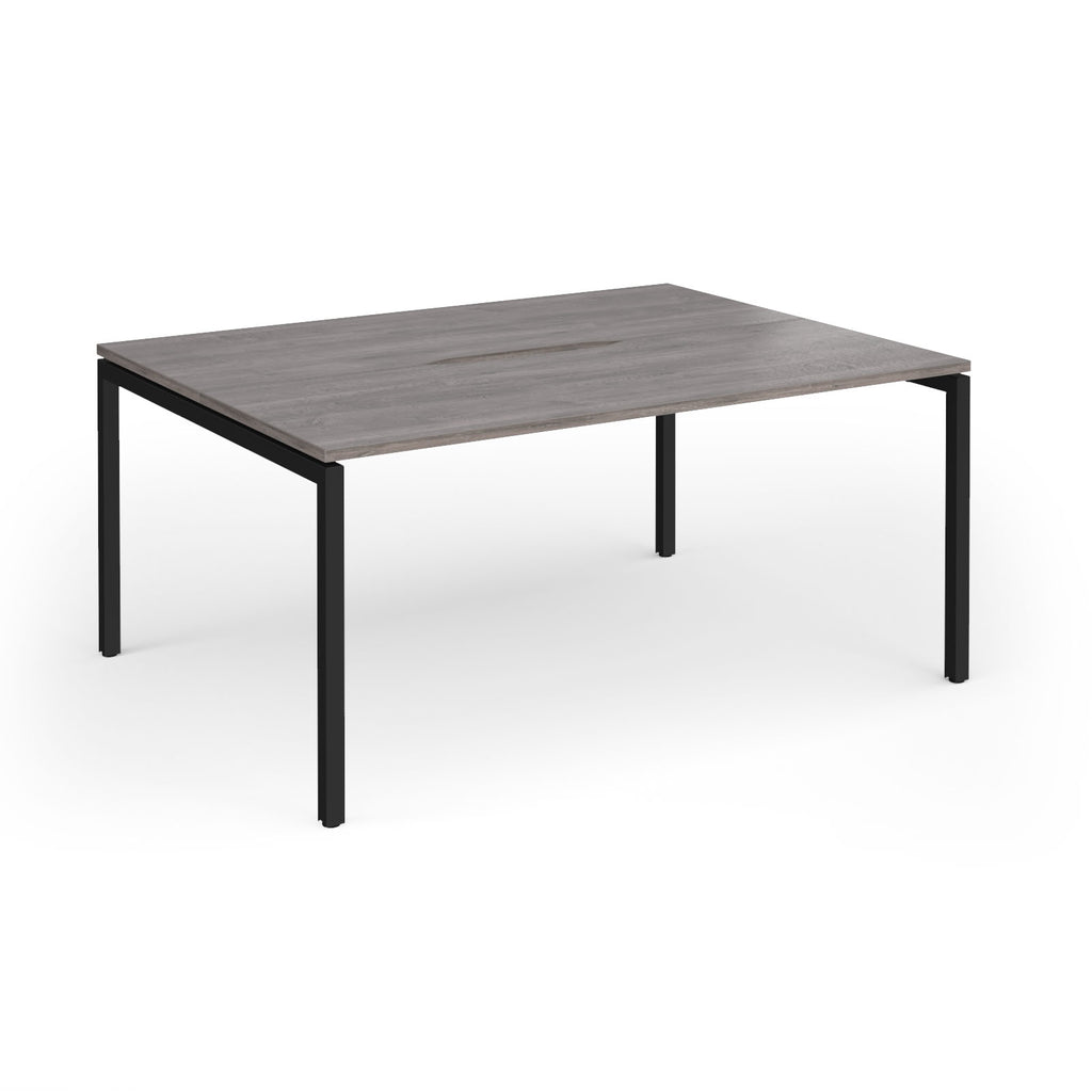Back-to-back desk with grey wood-effect top and black metal frame on a white background
