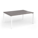 Back-to-back desk with grey wood-effect top and white metal frame on a white background