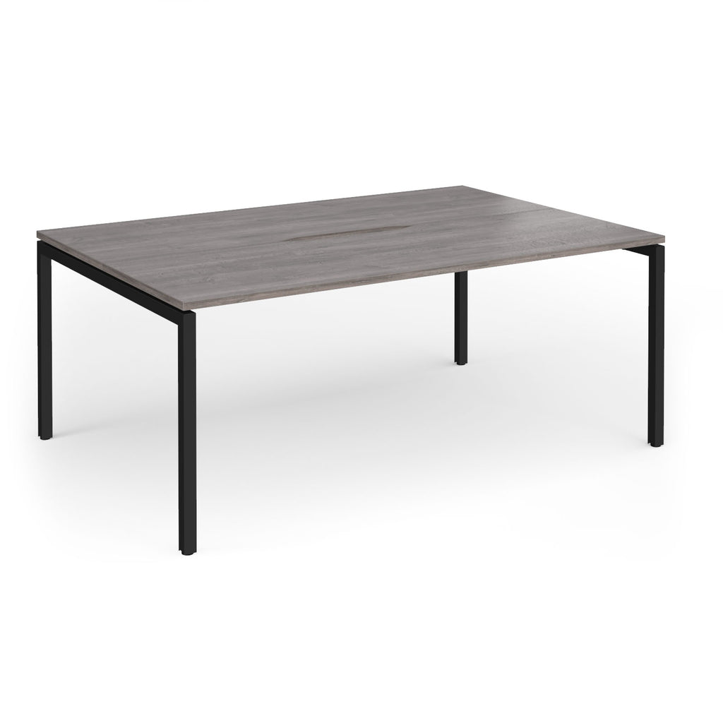 Back-to-back desk with grey wood-effect top and black metal frame on a white background