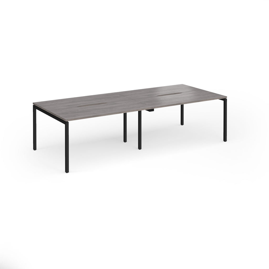 Office bench desks with grey wood-effect top and black legs on a white background