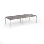 Office bench desks with grey wood-effect top and silver legs on a white background