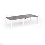 Office bench desks with grey wood-effect top and white legs on a white background