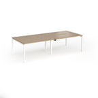 Office bench desks with wood-effect top and white legs on a white background