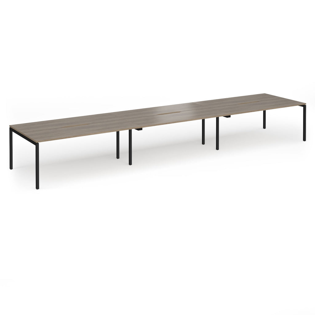 Triple back-to-back desk with wood-effect top and black legs on a white background
