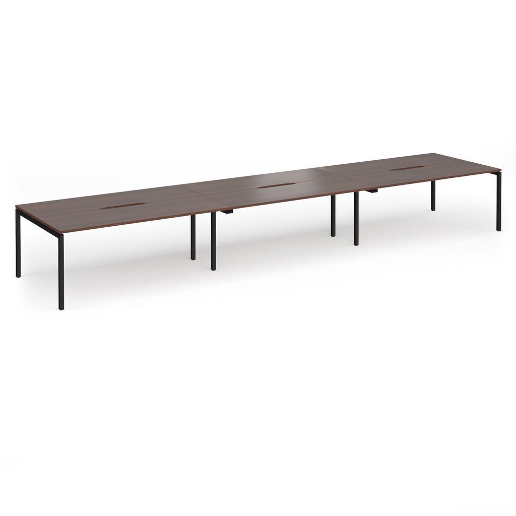 Triple back-to-back desk with wood-effect top and black legs on a white background
