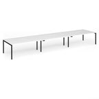 Triple back-to-back desk with white top and black legs on a white background