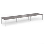 Triple back-to-back desk with grey wood-effect top and silver legs on a white background