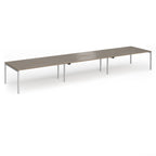 Triple back-to-back desk with wood-effect top and silver legs on a white background