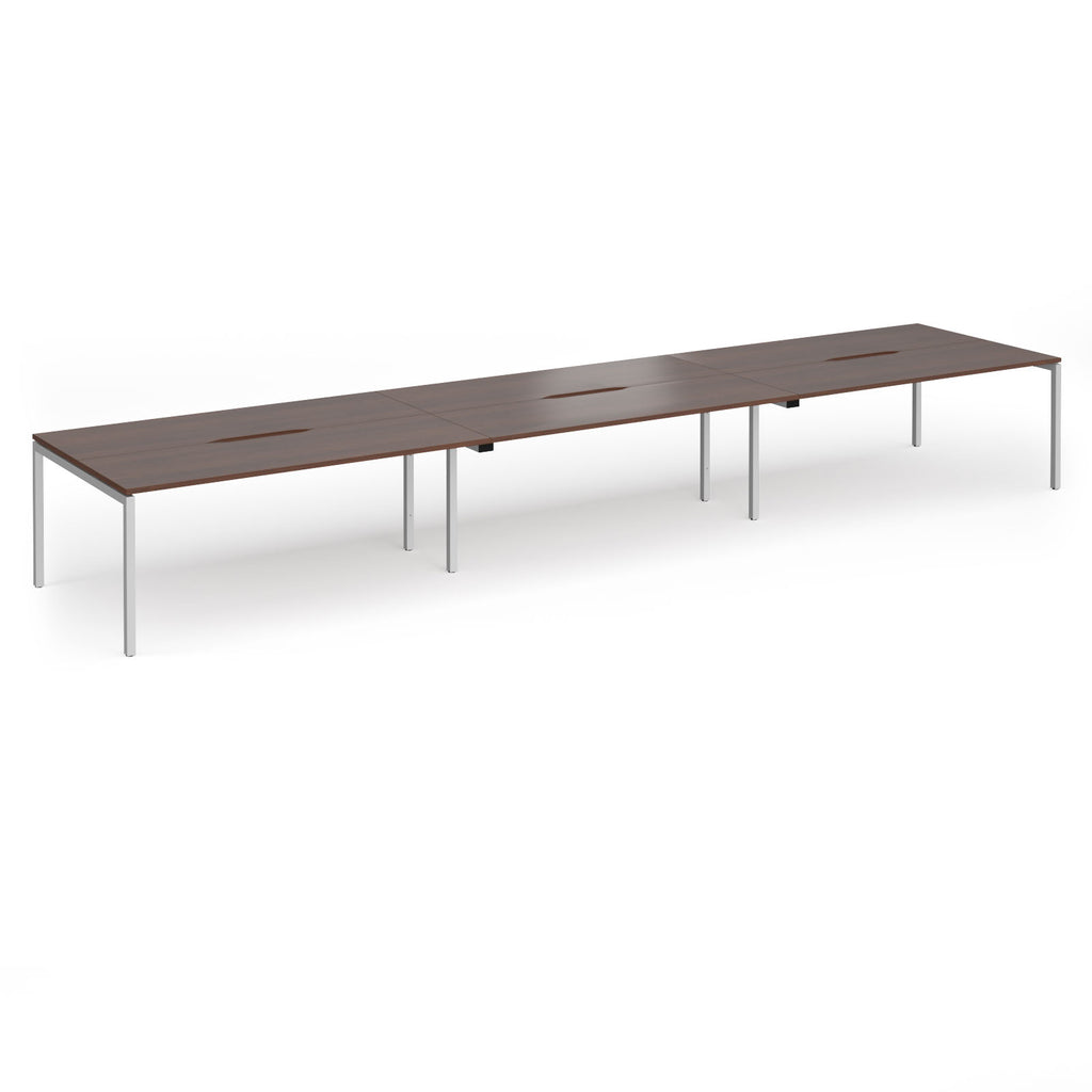 Triple back-to-back desk with wood-effect top and silver legs on a white background