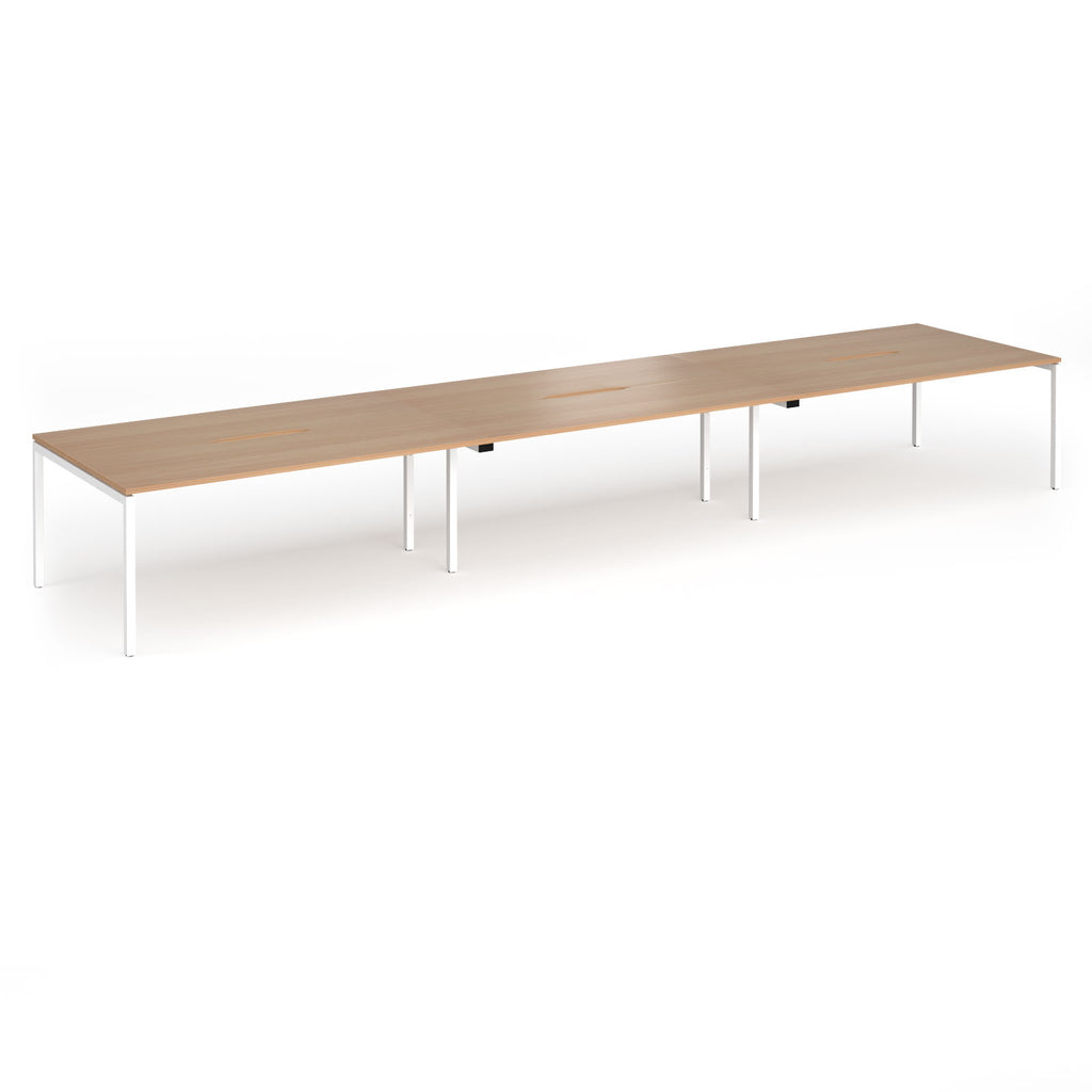 Triple back-to-back desk with wood-effect top and white legs on a white background