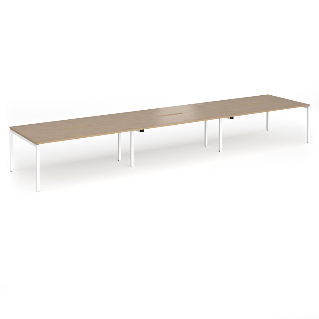 Triple back-to-back desk with wood-effect top and white legs on a white background