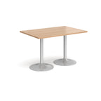 A rectangular table with a light wood-effect top and two silver pedestal bases, shown on a plain white background.