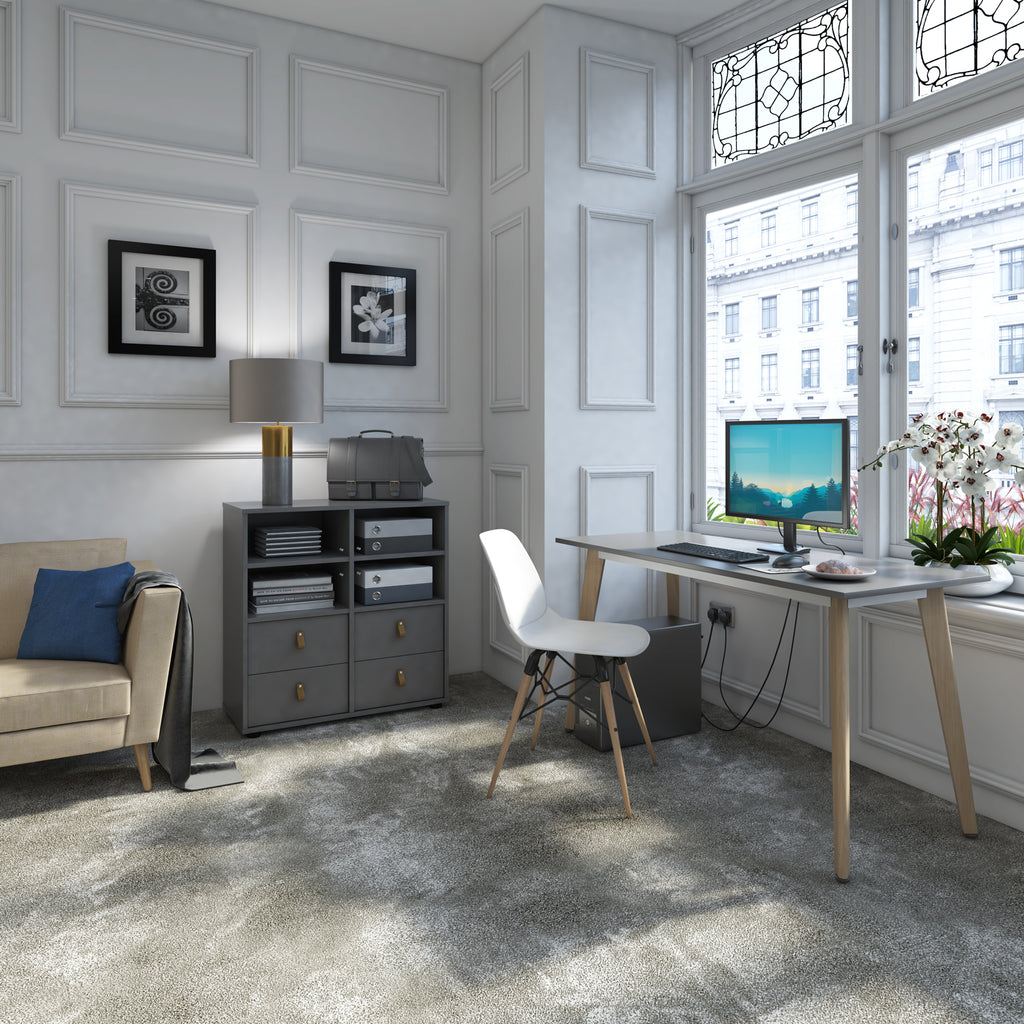Elegant home office setup with a minimalist wooden desk, computer workstation, upholstered chair, storage cabinet, and large window providing natural light in a classic interior.