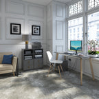 Elegant home office setup with a minimalist wooden desk, computer workstation, upholstered chair, storage cabinet, and large window providing natural light in a classic interior.
