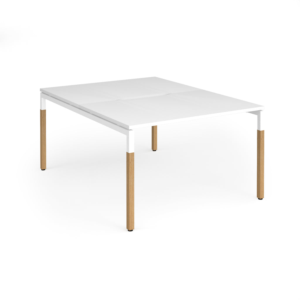 Back to back desk with white top and wooden legs on a white background