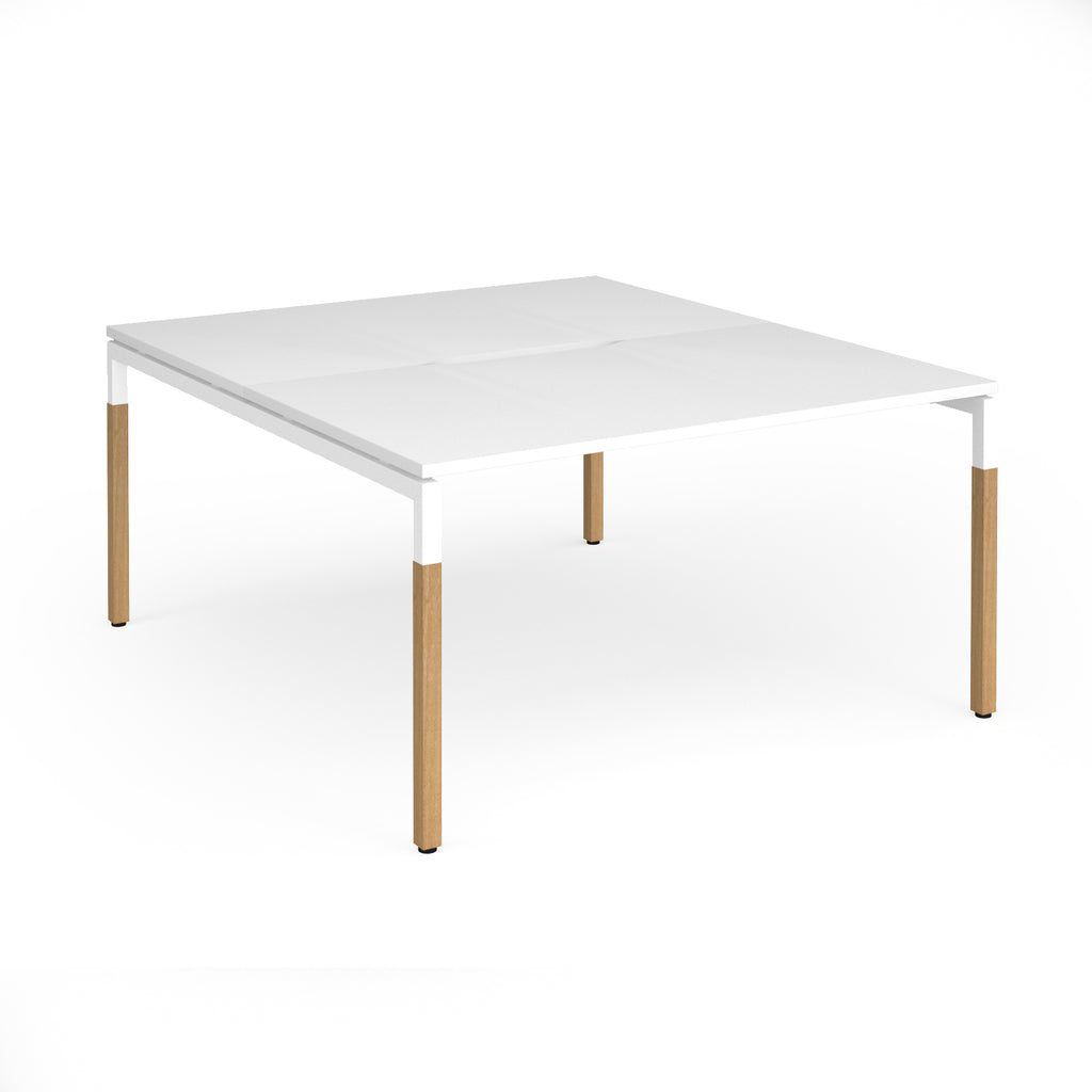 Back to back desk with white top and wooden legs on a white background