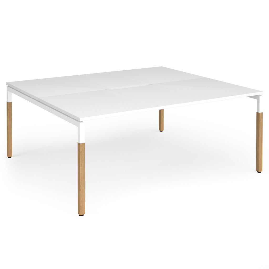 Back to back desk with white top and wooden legs on a white background