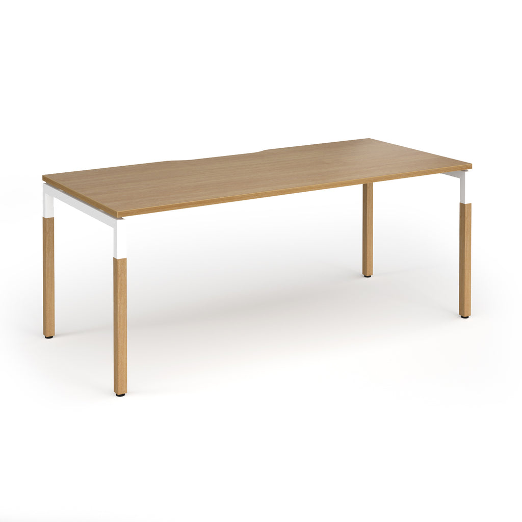 Straight desk with light oak wood grain top and legs with white frame on a white background