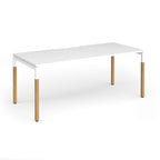 Straight desk with white top and wooden legs on a white background