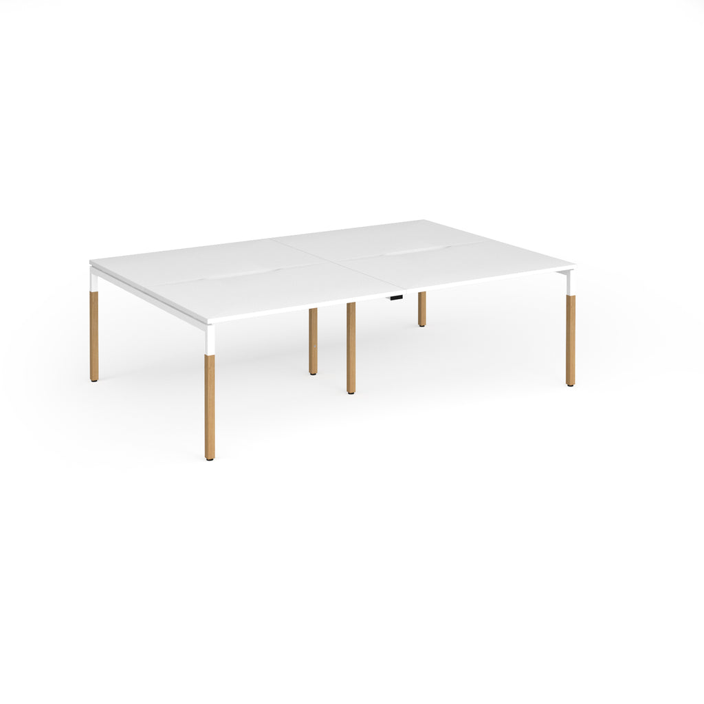 Double back to back desk with white top and wooden legs on a white background