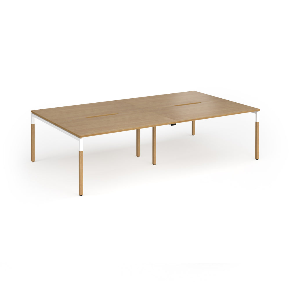 Double back to back desk with light oak wood grain top and legs with white frame on a white background