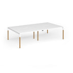 Double back to back desk with white top and wooden legs on a white background