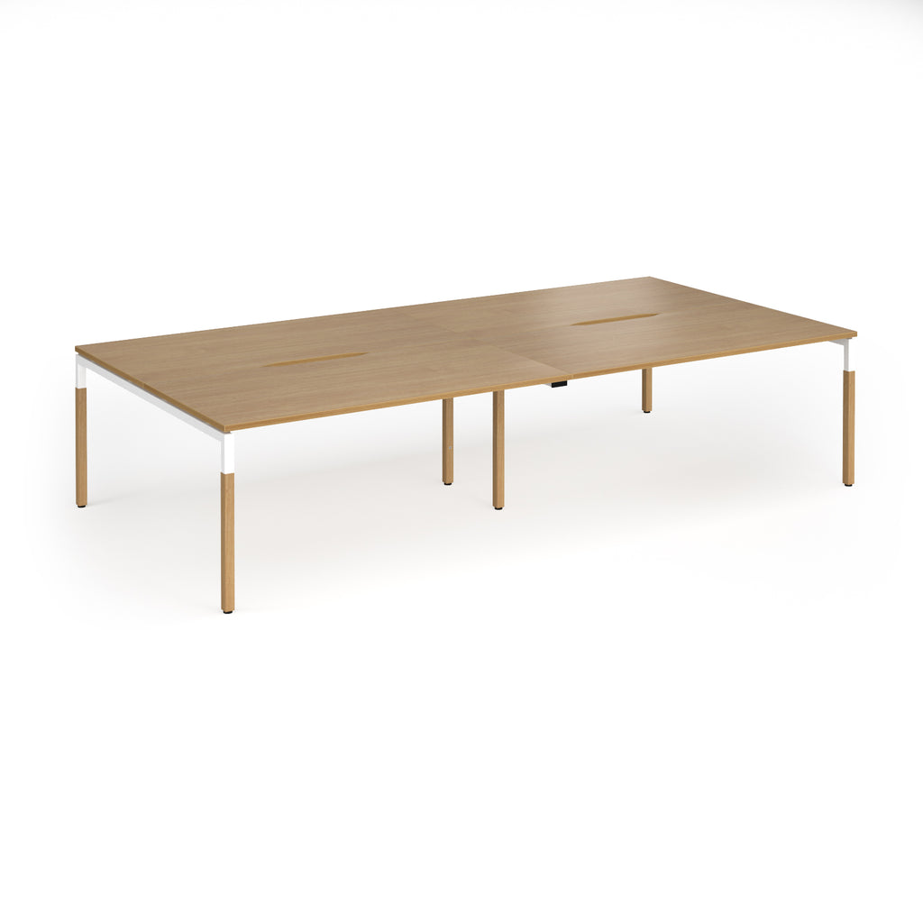 Double back to back desk with light oak wood grain top and legs with white frame on a white background