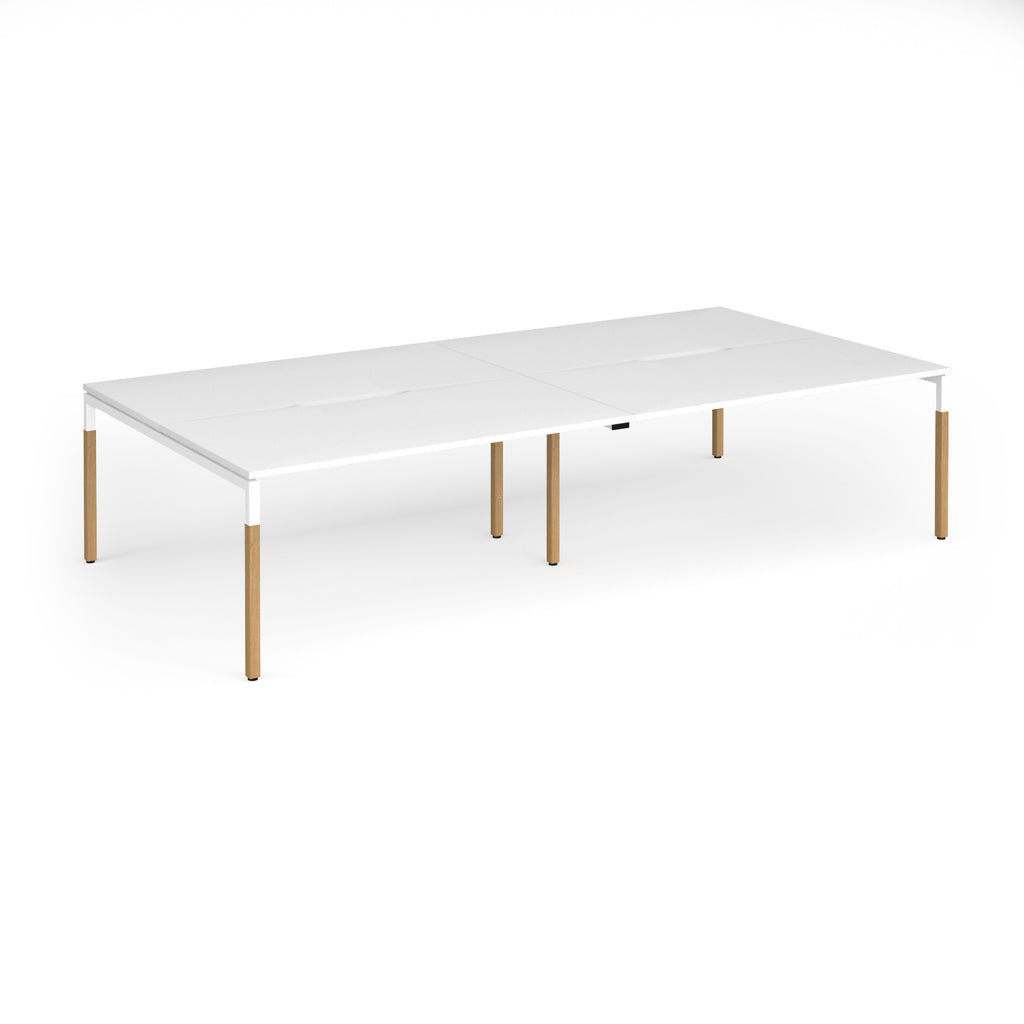Double back to back desk with white top and wooden legs on a white background