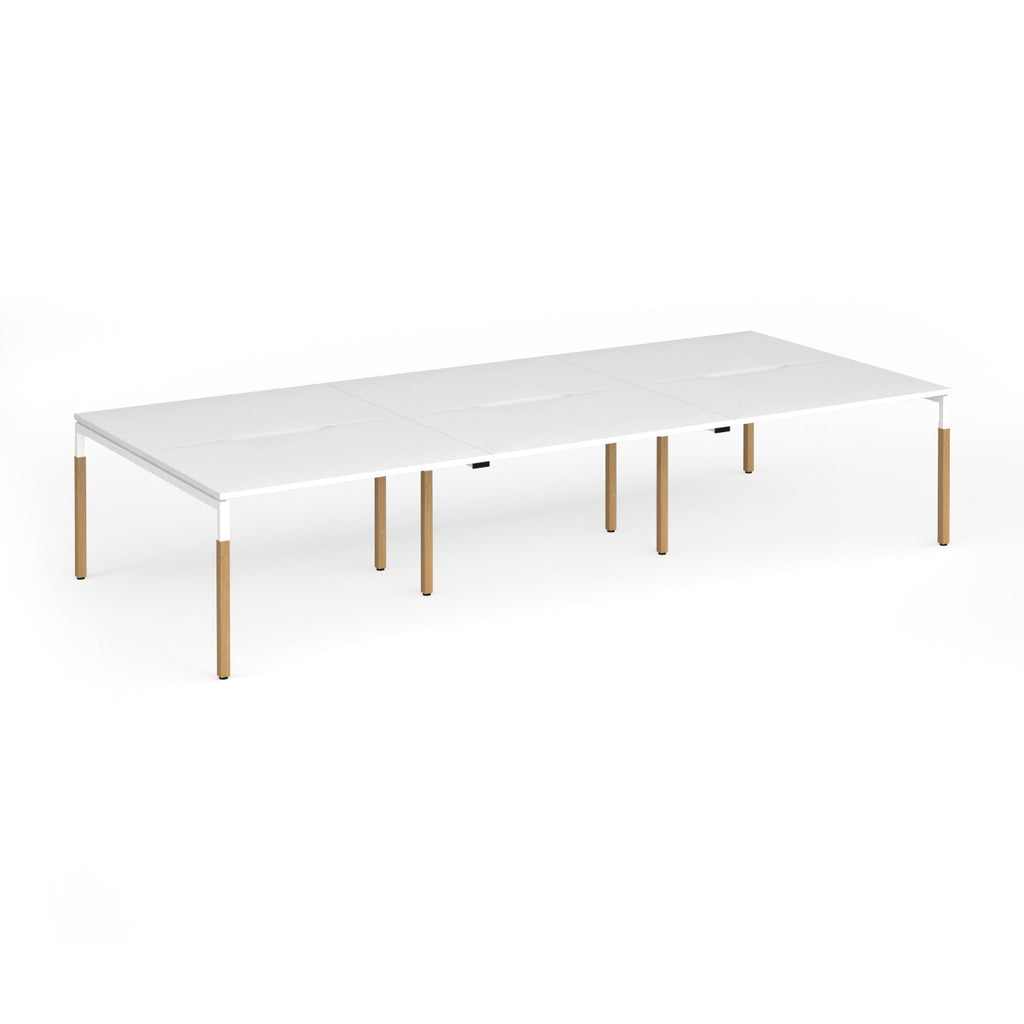 Triple back to back desk with white top and wooden legs on a white background