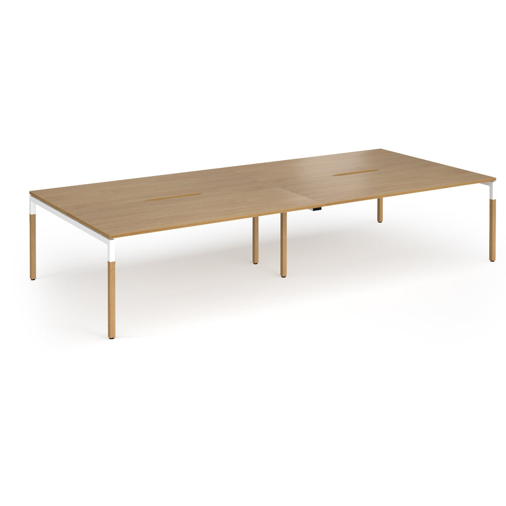 Double back to back desk with light oak wood grain top and legs with white frame on a white background