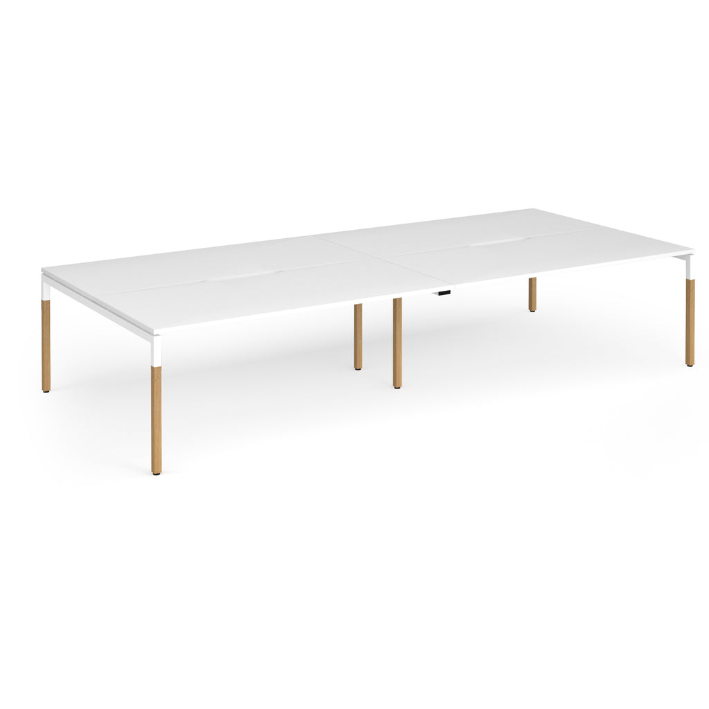 Double back to back desk with white top and wooden legs on a white background