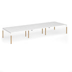 Triple back to back desk with white top and wooden legs on a white background