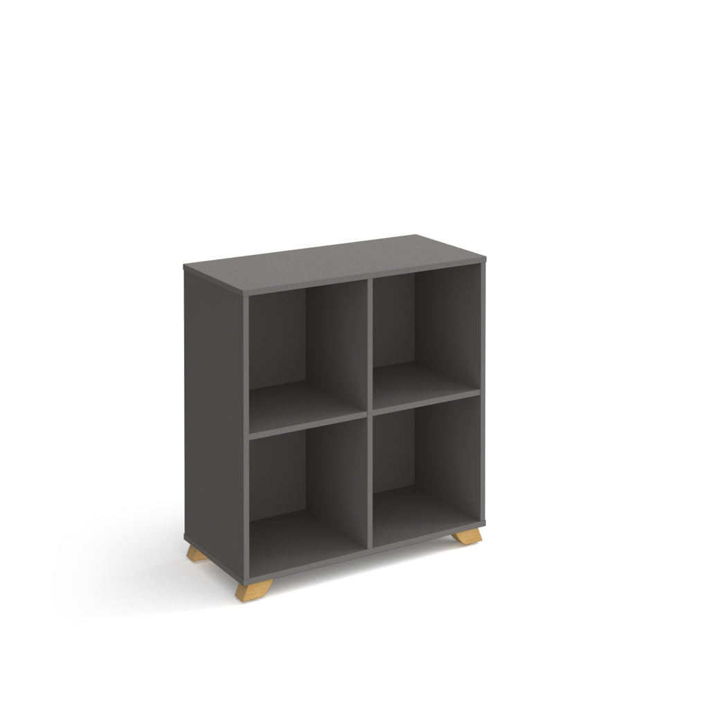 A dark grey 4-compartment cube storage shelf with light wood legs, shown on a plain white background.