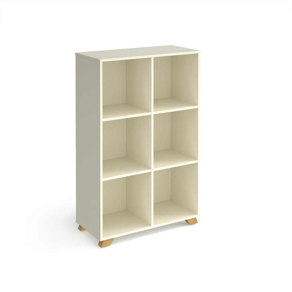 A modern 6-compartment cube storage shelf in a warm off-white finish with small natural wood feet, shown on a plain white background.
