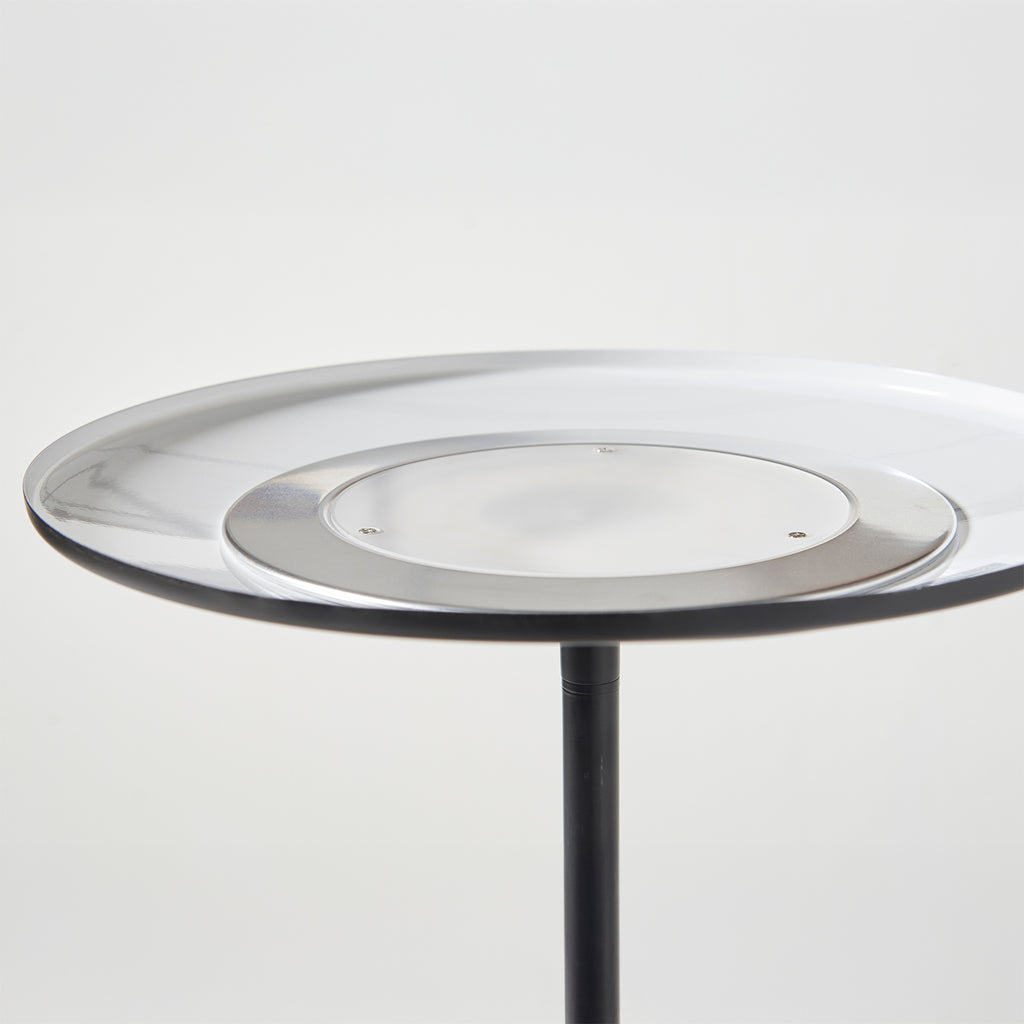 Round lamp with a black metal base on a white background