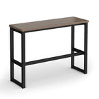 A modern high table with a dark brown wood-look rectangular top and a black metal frame with a lower support rail, shown on a plain white background.