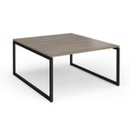 Back-to-back desk with wood-effect top and black metal legs on a white background