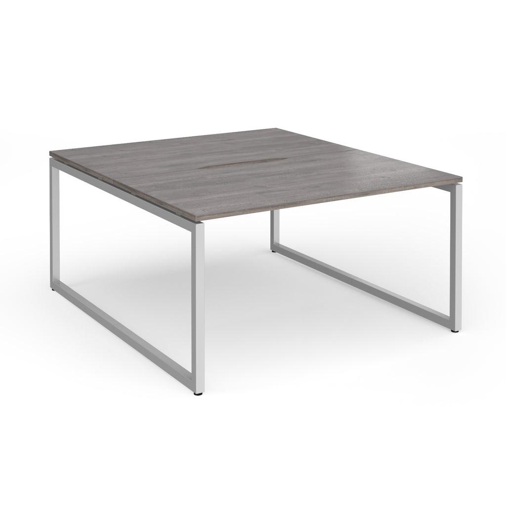 Back-to-back desk with grey wood-effect top and silver metal legs on a white background