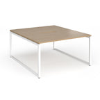 Back-to-back desk with wood-effect top and white metal legs on a white background
