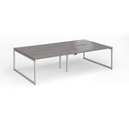 Back-to-back bench desk with grey wood-effect top and silver metal legs on a white background