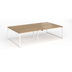 Back-to-back bench desk with wood-effect top and white metal legs on a white background