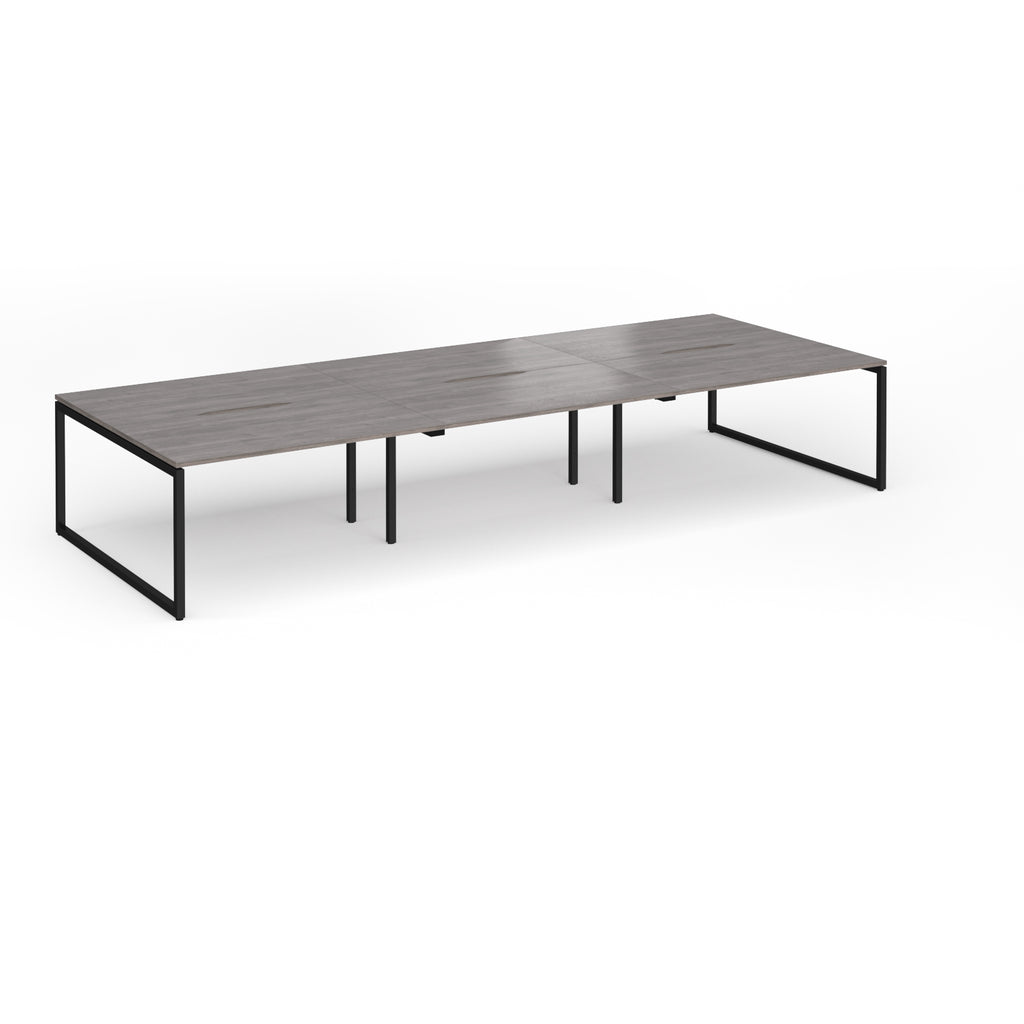Long back-to-back desk with grey wood-effect top and black metal legs on a white background