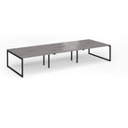 Long back-to-back desk with grey wood-effect top and black metal legs on a white background
